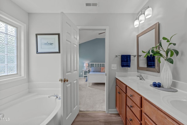 2508 Hidden Meadow Dr, Fuquay Varina, NC 27526 - full bath featuring connected bathroom, plenty of natural light, double vanity, and a garden tub