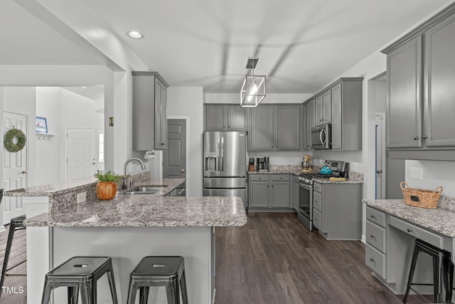2508 Hidden Meadow Dr, Fuquay Varina, NC 27526 - kitchen featuring appliances with stainless steel finishes, gray cabinets, a breakfast bar, a peninsula, and recessed lighting