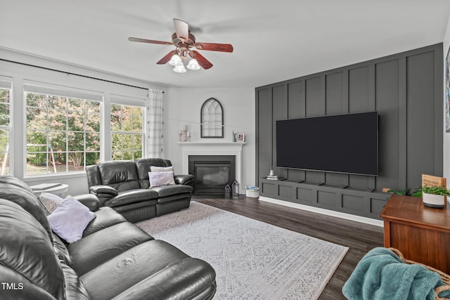 2508 Hidden Meadow Dr, Fuquay Varina, NC 27526 - living area with a ceiling fan, a glass covered fireplace, dark wood-style flooring, and a decorative wall
