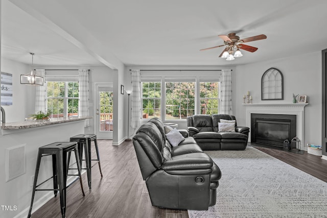 2508 Hidden Meadow Dr, Fuquay Varina, NC 27526 - living area with healthy amount of natural light, wood finished floors, a ceiling fan, and a fireplace with flush hearth