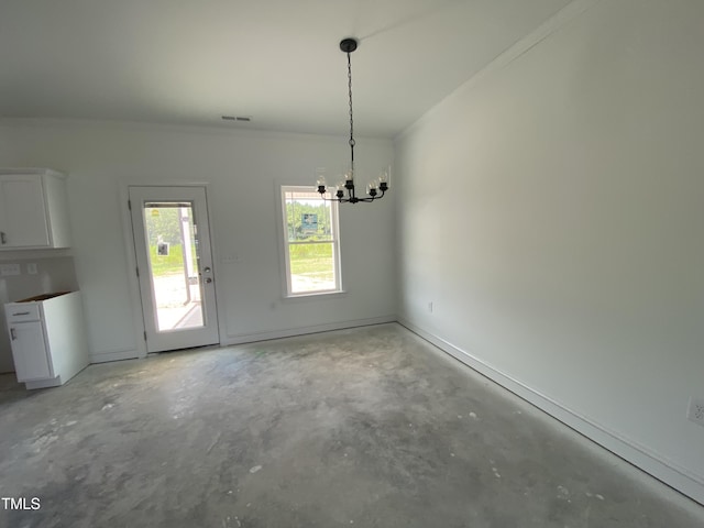 202 Rae Dr, Pikeville, NC 27863 - unfurnished dining area featuring unfinished concrete flooring and a chandelier