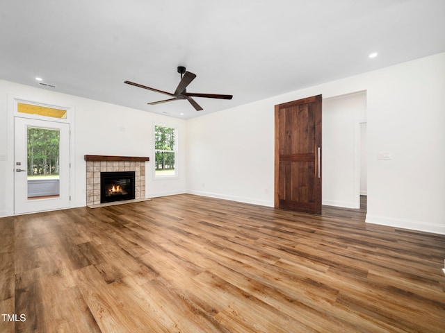 10 Hermitage, Franklinton, NC 27525 - unfurnished living room with wood finished floors, a ceiling fan, a tile fireplace, and recessed lighting