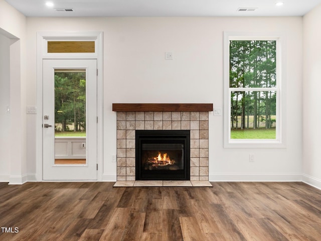 10 Hermitage, Franklinton, NC 27525 - unfurnished living room with wood finished floors, a tile fireplace, and recessed lighting