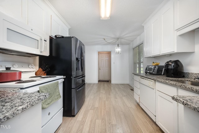 104 Fairfield Dr, Goldsboro, NC 27530 - kitchen with white appliances, white cabinets, light wood-type flooring, light stone counters, and a textured ceiling