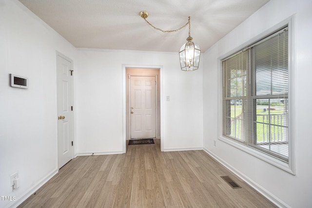 104 Fairfield Dr, Goldsboro, NC 27530 - unfurnished dining area with light wood finished floors and a chandelier