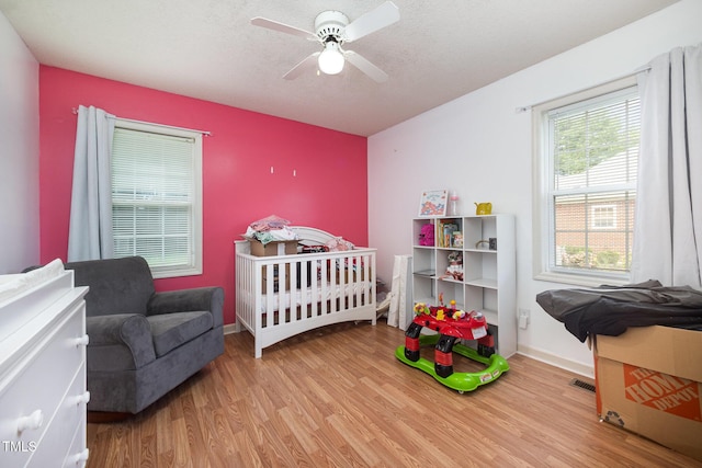 104 Fairfield Dr, Goldsboro, NC 27530 - bedroom with wood finished floors, ceiling fan, and a textured ceiling