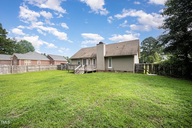 104 Fairfield Dr, Goldsboro, NC 27530 - rear view of house with crawl space, a fenced backyard, a wooden deck, and a chimney