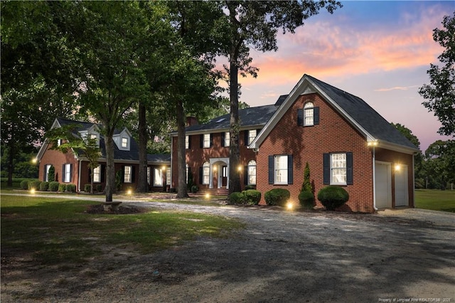 387 Three Bridge Rd, Dunn, NC 28334 - view of front of house featuring driveway, an attached garage, brick siding, and a front yard