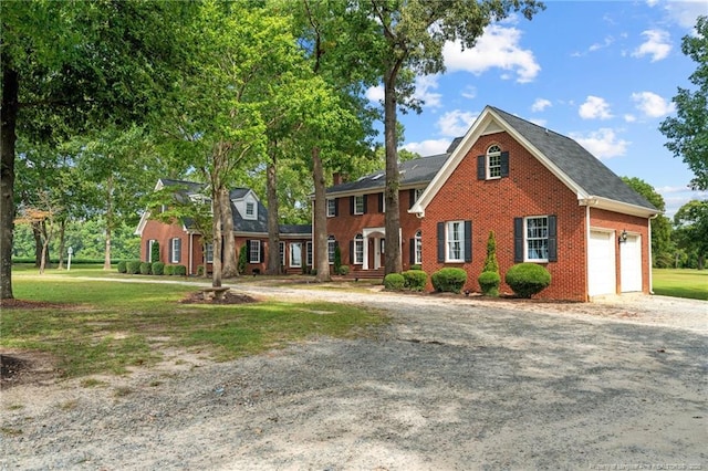 387 Three Bridge Rd, Dunn, NC 28334 - view of front of house featuring an attached garage, brick siding, driveway, and a front lawn