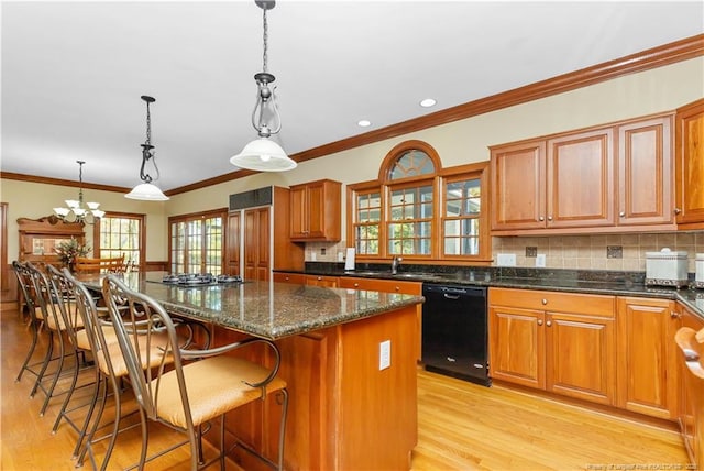 387 Three Bridge Rd, Dunn, NC 28334 - kitchen with dishwasher, light wood-type flooring, a center island, backsplash, and ornamental molding