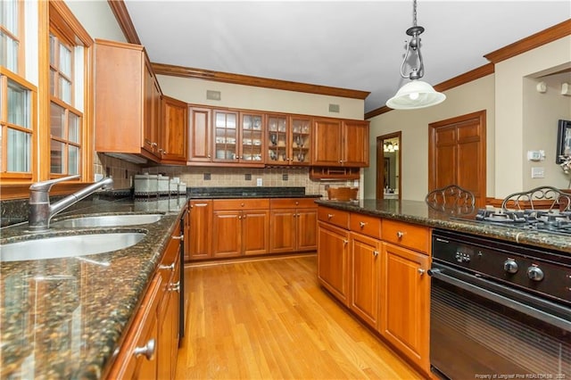 387 Three Bridge Rd, Dunn, NC 28334 - kitchen featuring oven, crown molding, brown cabinets, and tasteful backsplash