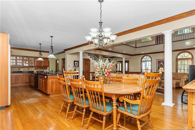 387 Three Bridge Rd, Dunn, NC 28334 - dining space with decorative columns, crown molding, light wood-type flooring, and a chandelier