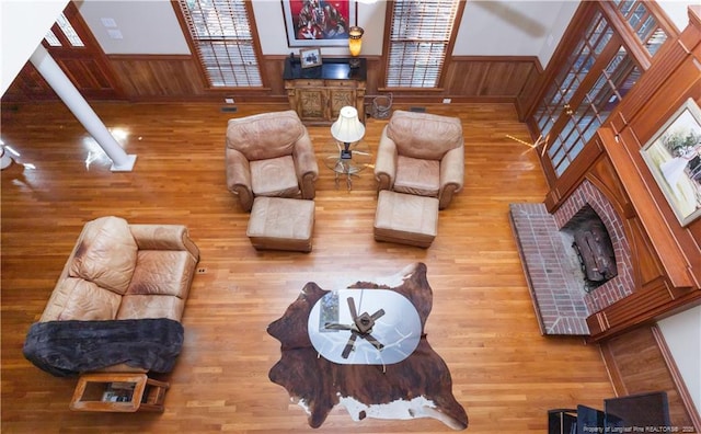 387 Three Bridge Rd, Dunn, NC 28334 - living area with wood finished floors, a wainscoted wall, wood walls, and a fireplace
