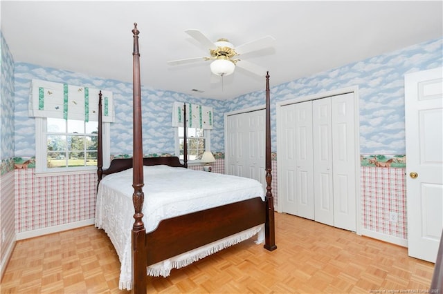 387 Three Bridge Rd, Dunn, NC 28334 - bedroom with wallpapered walls, multiple closets, and ceiling fan