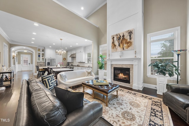 1089 Queensdale Dr, Cary, NC 27519 - living area featuring ornamental molding, a chandelier, a glass covered fireplace, dark wood-type flooring, and recessed lighting