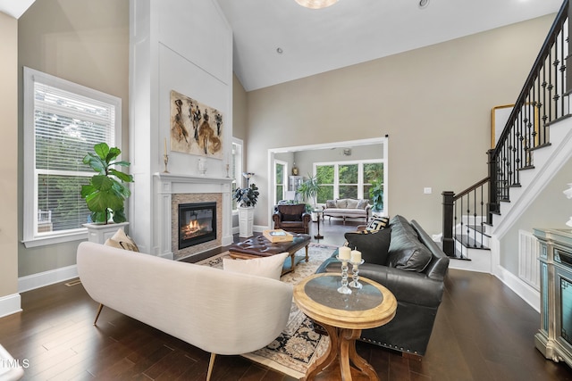 1089 Queensdale Dr, Cary, NC 27519 - living area featuring high vaulted ceiling, a glass covered fireplace, stairway, and dark wood-style floors