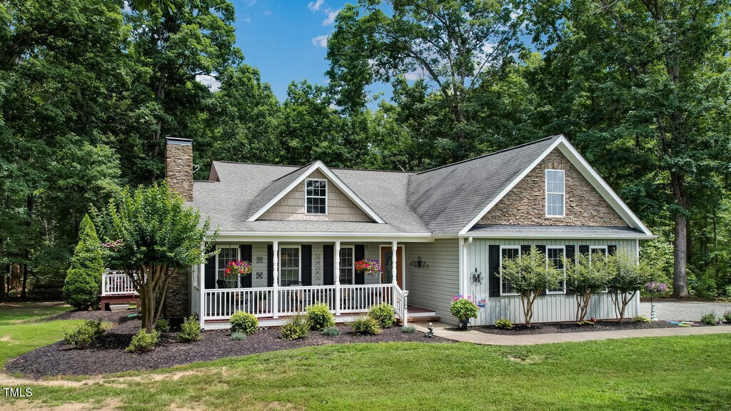 150 Bud Rd, Reidsville, NC 27320 - view of front facade with covered porch, a front yard, a chimney, and roof with shingles
