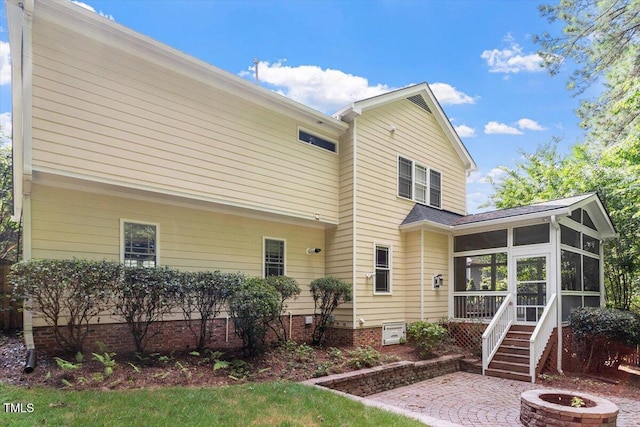 109 Gullane Ct, Apex, NC 27502 - back of property featuring a sunroom, a fire pit, and a patio