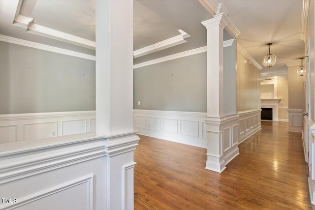 109 Gullane Ct, Apex, NC 27502 - hallway featuring decorative columns, wood finished floors, a decorative wall, ornamental molding, and wainscoting
