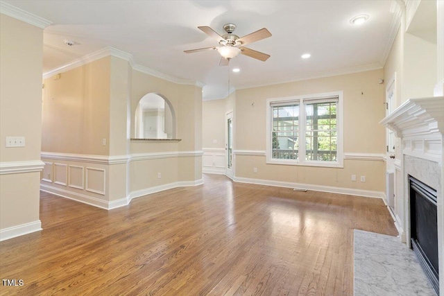 109 Gullane Ct, Apex, NC 27502 - unfurnished living room with ceiling fan, light wood-style flooring, a fireplace with flush hearth, ornamental molding, and recessed lighting