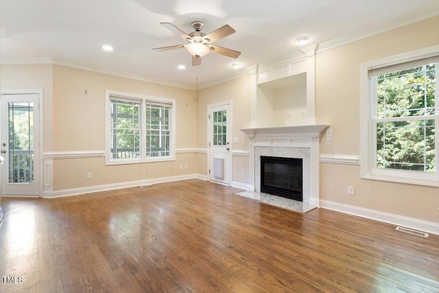 109 Gullane Ct, Apex, NC 27502 - unfurnished living room featuring ceiling fan, healthy amount of natural light, wood finished floors, a high end fireplace, and recessed lighting