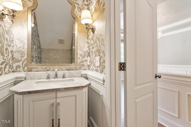 109 Gullane Ct, Apex, NC 27502 - bathroom with a decorative wall, vanity, a wainscoted wall, and wallpapered walls