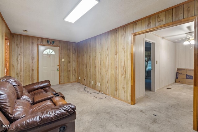 3702 Danube Ln, Durham, NC 27704 - carpeted living area with wooden walls, ornamental molding, and ceiling fan