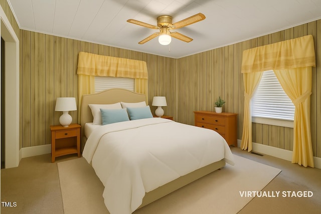 3702 Danube Ln, Durham, NC 27704 - bedroom featuring carpet floors, ornamental molding, wooden walls, and a ceiling fan