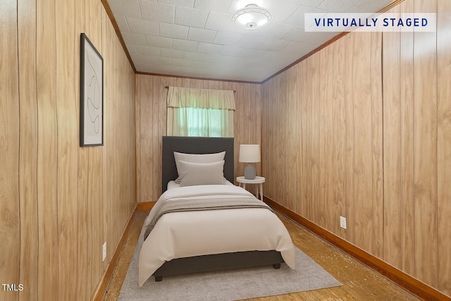 3702 Danube Ln, Durham, NC 27704 - bedroom featuring ornamental molding, wood walls, and wood finished floors