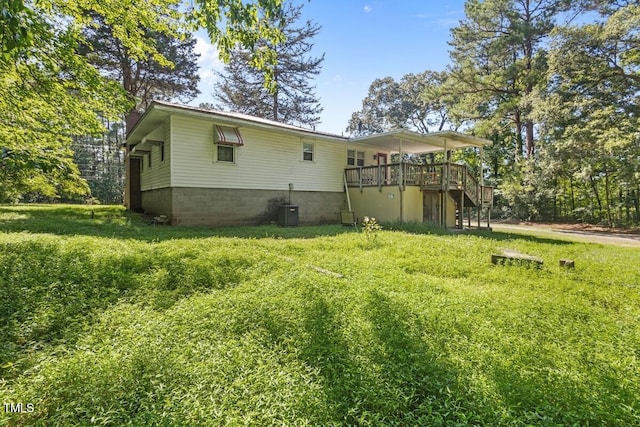 3702 Danube Ln, Durham, NC 27704 - back of property featuring stairs, a wooden deck, and a lawn