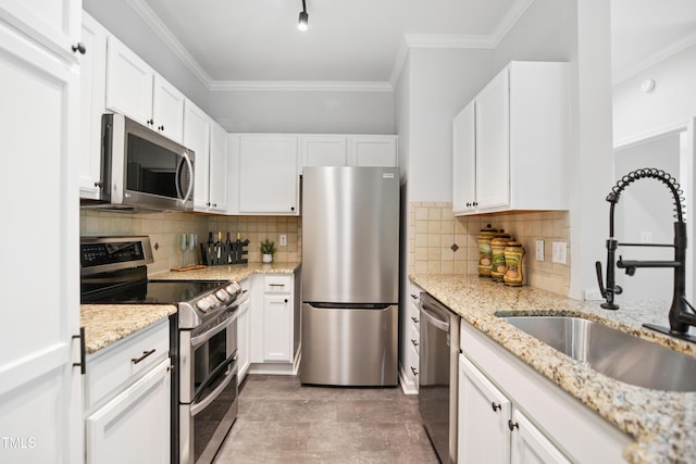 105 Fountain Ridge Pl, Holly Springs, NC 27540 - kitchen with appliances with stainless steel finishes, crown molding, white cabinets, and backsplash