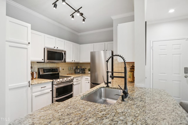 105 Fountain Ridge Pl, Holly Springs, NC 27540 - kitchen featuring stainless steel appliances, backsplash, white cabinets, light stone counters, and crown molding
