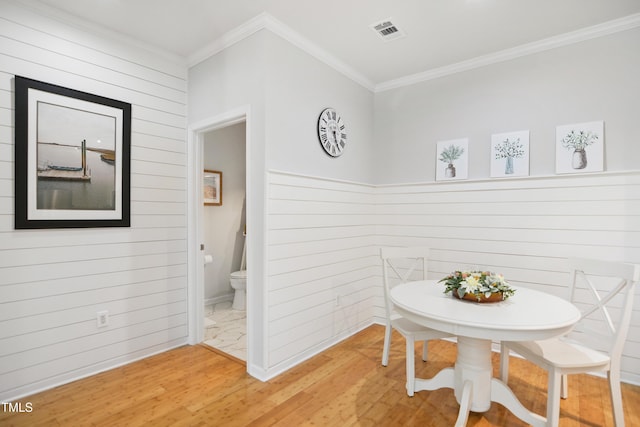 105 Fountain Ridge Pl, Holly Springs, NC 27540 - dining room featuring light wood finished floors, wood walls, and ornamental molding