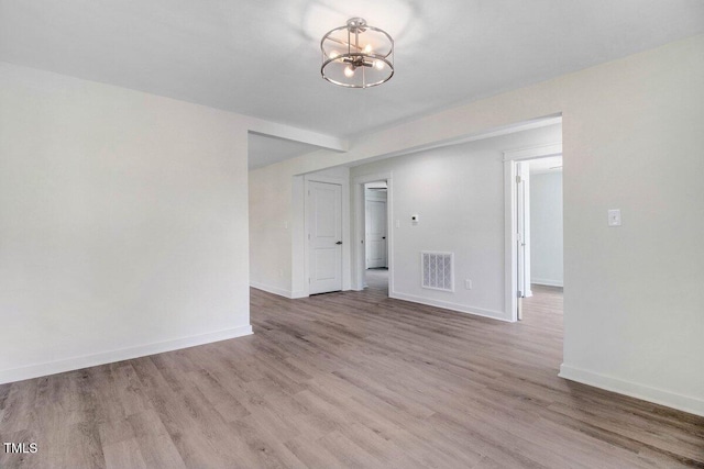 400 E Townsend St, Dunn, NC 28334 - unfurnished room featuring a chandelier and wood finished floors