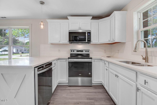 400 E Townsend St, Dunn, NC 28334 - kitchen with stainless steel appliances, healthy amount of natural light, white cabinets, and light wood-style flooring