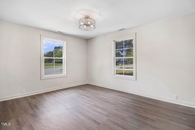 400 E Townsend St, Dunn, NC 28334 - empty room featuring dark wood-type flooring and healthy amount of natural light