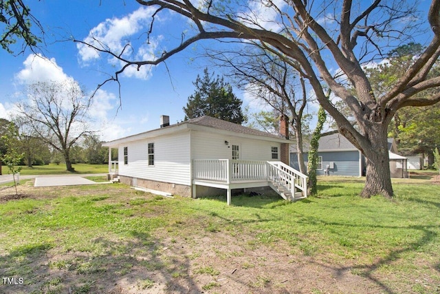 400 E Townsend St, Dunn, NC 28334 - view of side of home with a chimney, a wooden deck, a lawn, and crawl space