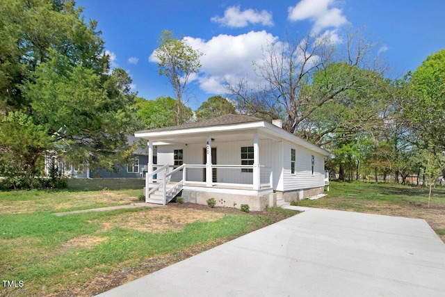 400 E Townsend St, Dunn, NC 28334 - view of front of house featuring covered porch, a front yard, and a chimney