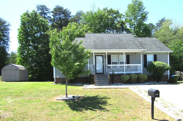 409 James Toney Dr, Elon, NC 27244 - view of front of property with a porch, a shed, a front yard, and roof with shingles