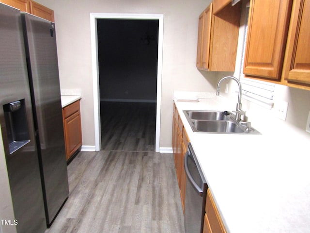 409 James Toney Dr, Elon, NC 27244 - kitchen with stainless steel appliances, wood finished floors, light countertops, and brown cabinetry