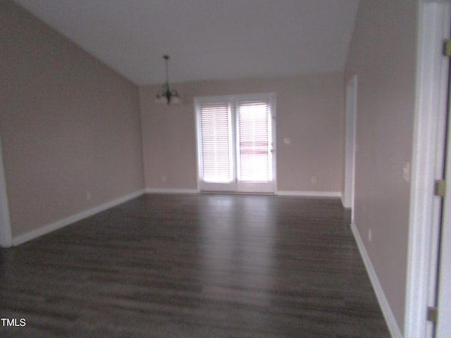 409 James Toney Dr, Elon, NC 27244 - spare room featuring vaulted ceiling, wood finished floors, and a chandelier