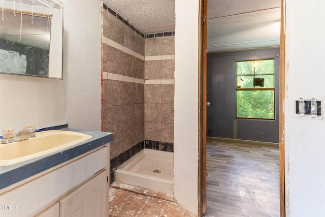 3170 Loblolly Ln, Wake Forest, NC 27587 - full bathroom featuring a stall shower, vanity, and a textured ceiling