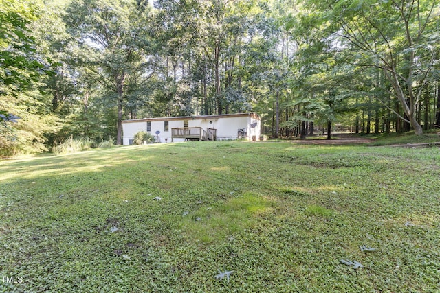 3170 Loblolly Ln, Wake Forest, NC 27587 - view of grassy yard with a wooden deck