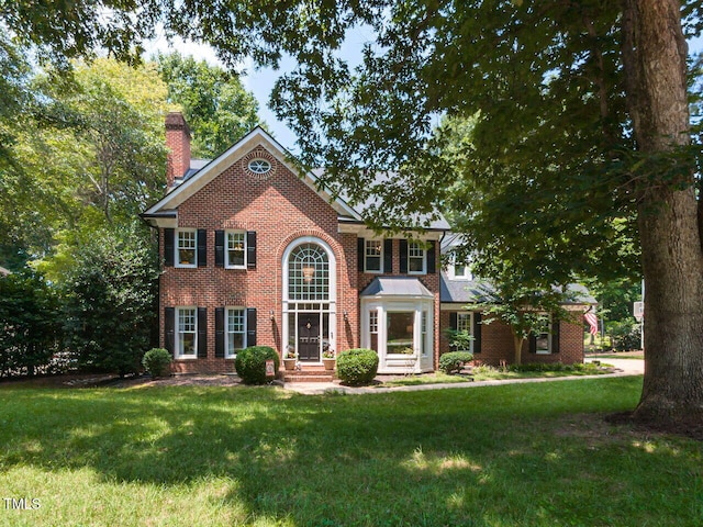 5032 Salem Ridge Rd, Holly Springs, NC 27540 - view of front of property with a chimney, brick siding, and a front lawn