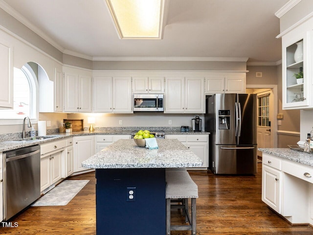 5032 Salem Ridge Rd, Holly Springs, NC 27540 - kitchen with stainless steel appliances, white cabinets, crown molding, light stone countertops, and a center island