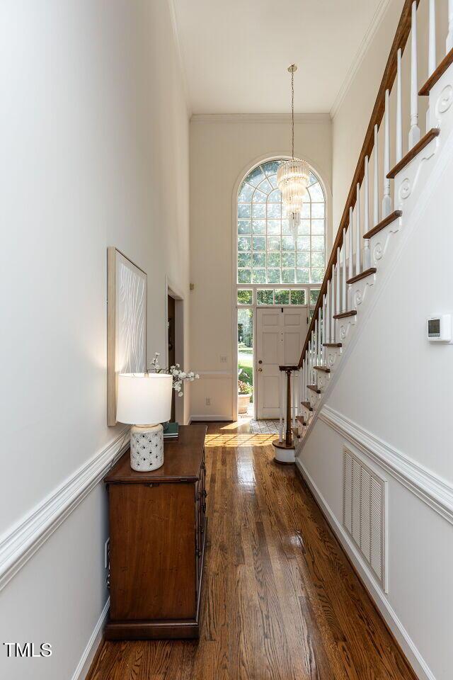 5032 Salem Ridge Rd, Holly Springs, NC 27540 - entrance foyer featuring ornamental molding, wood finished floors, a chandelier, and stairs