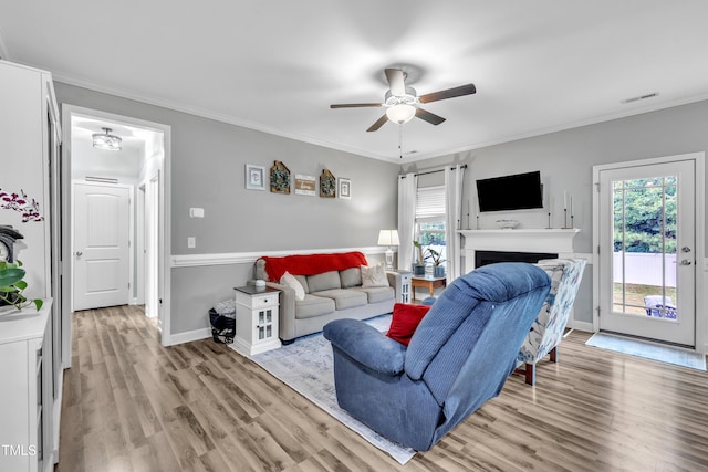 115 Creech Place Dr, Benson, NC 27504 - living room featuring light wood-style floors, ceiling fan, ornamental molding, and a fireplace