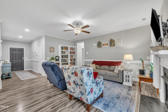 115 Creech Place Dr, Benson, NC 27504 - living area featuring ceiling fan, wood finished floors, a fireplace with flush hearth, crown molding, and recessed lighting