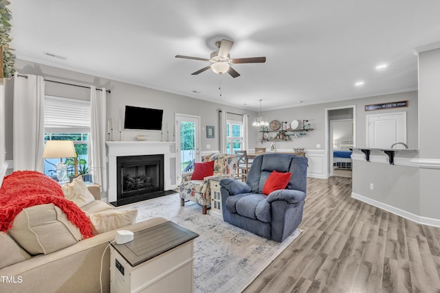 115 Creech Place Dr, Benson, NC 27504 - living area featuring ornamental molding, a ceiling fan, a fireplace, light wood-style floors, and a chandelier