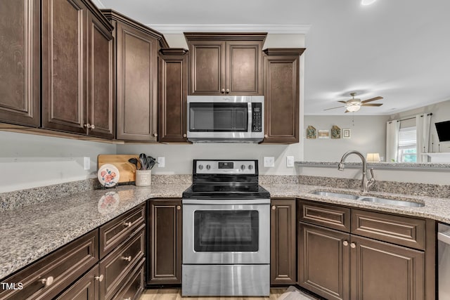 115 Creech Place Dr, Benson, NC 27504 - kitchen featuring stainless steel appliances, dark brown cabinets, light stone counters, and a ceiling fan
